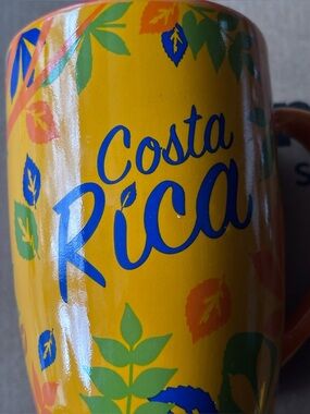 Costa Yellow Travel Tumbler with Blue Lettering and Green Leaf Accents